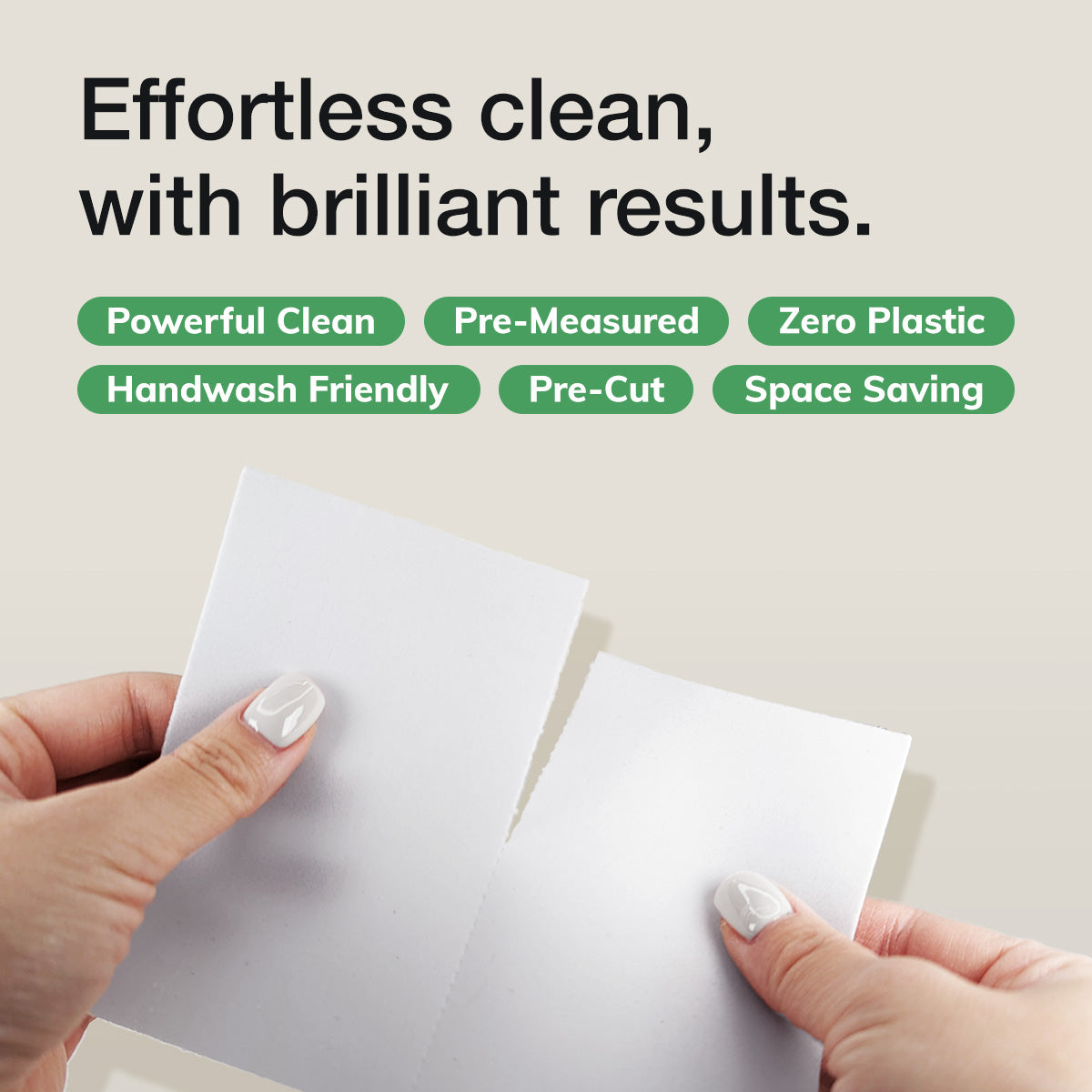 Hand holding a torn Laundry Leaf sheet with text that reads Effortless clean, with brilliant results.